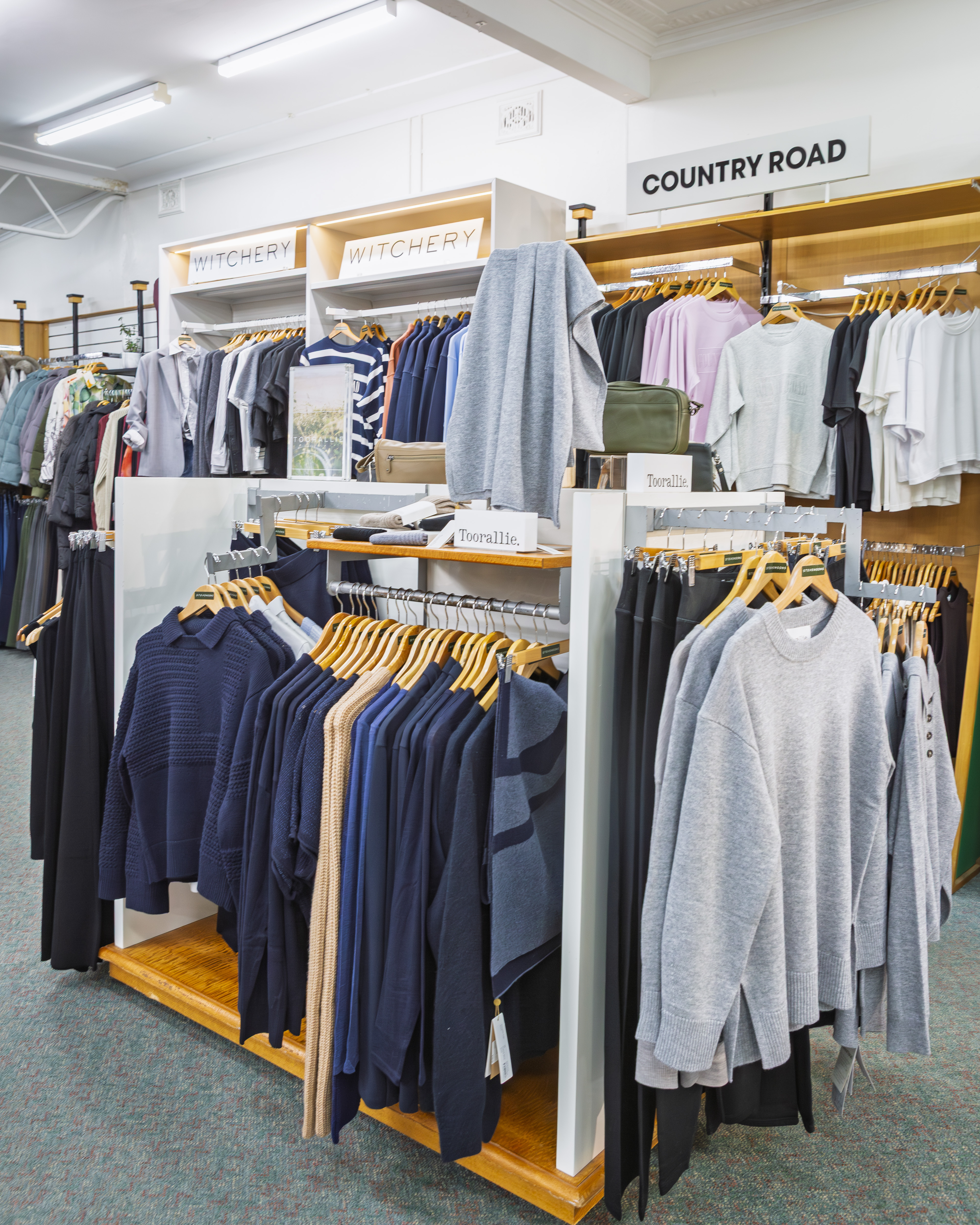 Witchery and Country Road ladies clothing displayed on timber shelving.