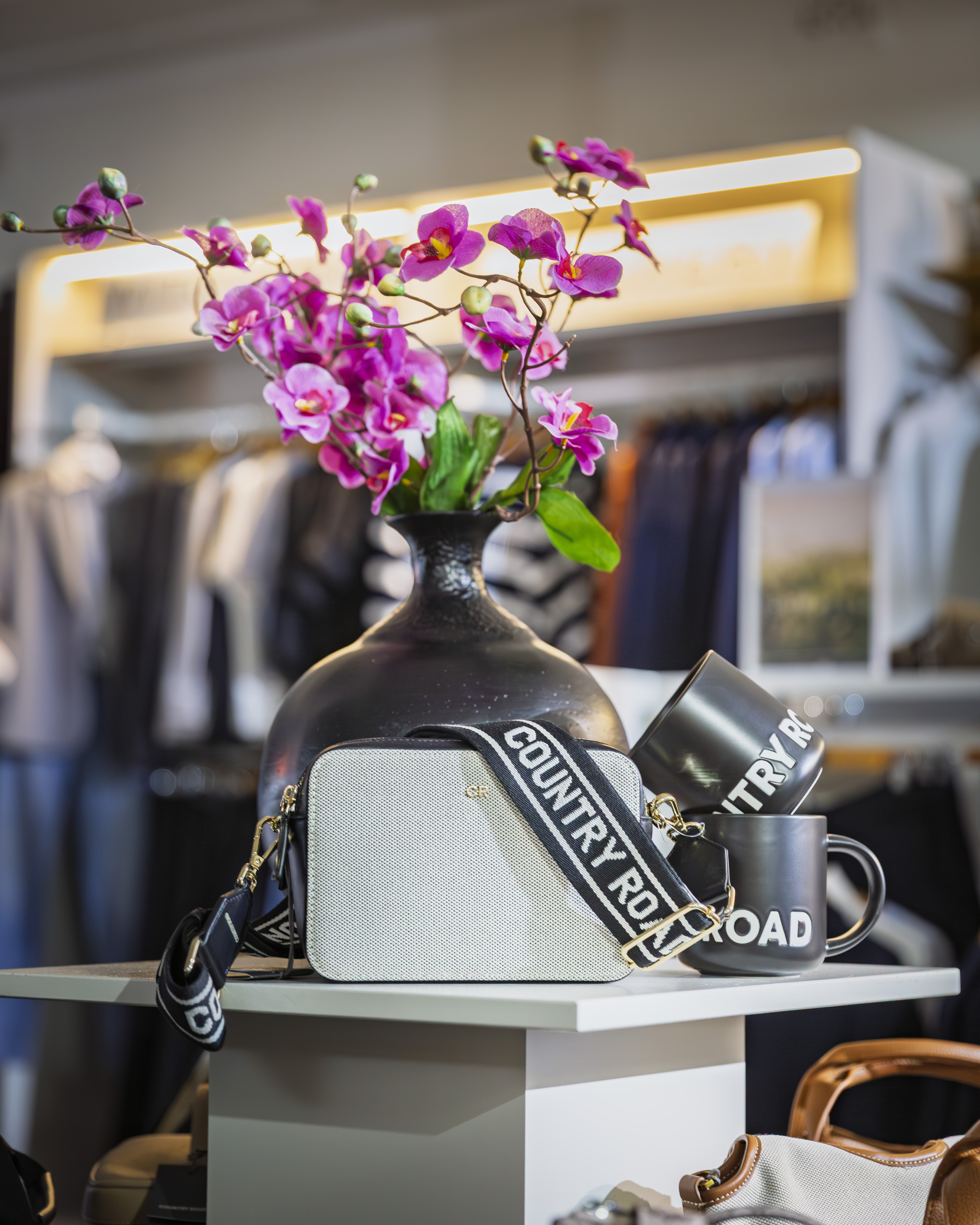 Country Road bag and mugs displayed with orchids inside Stevensons The Store.