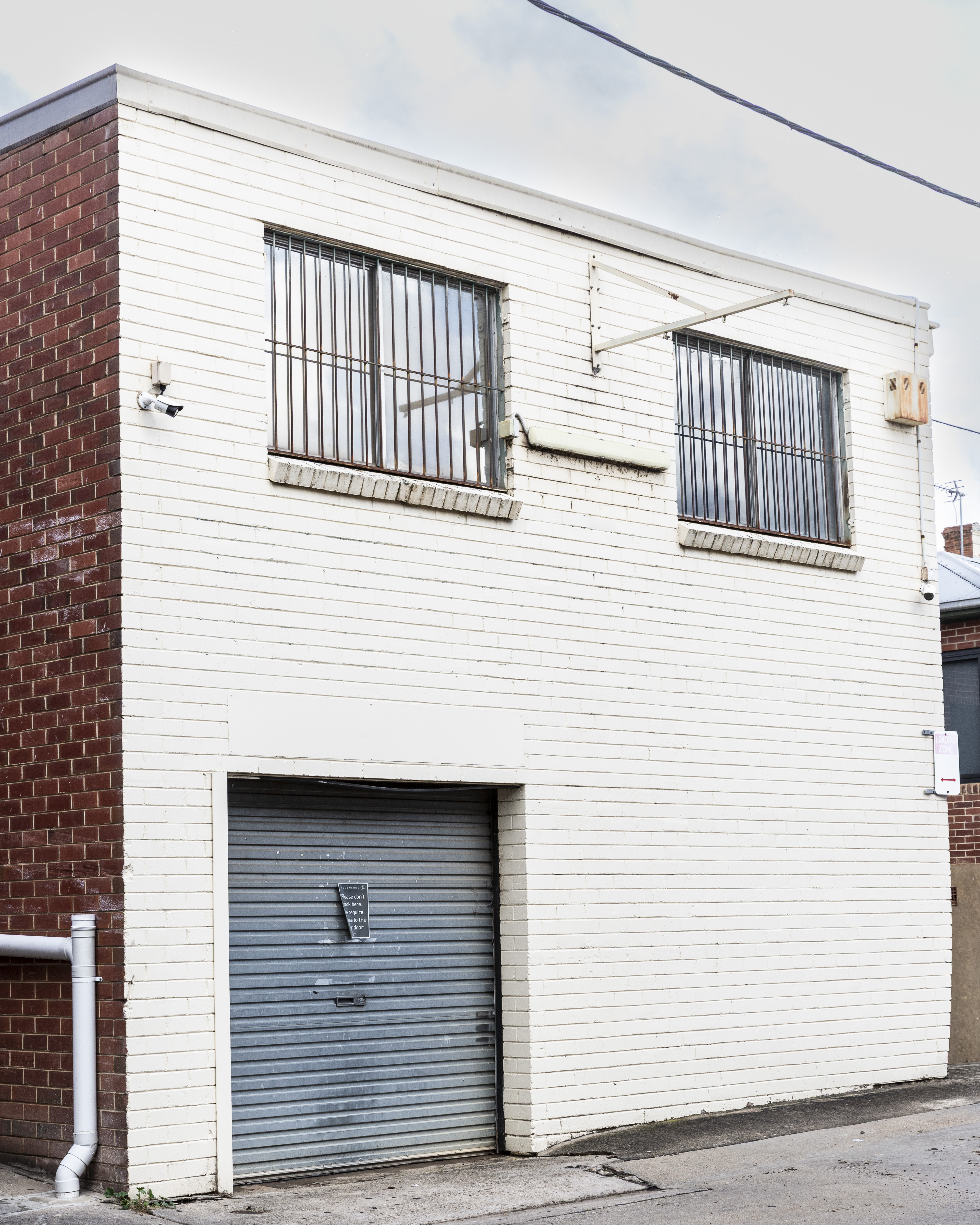 Rear exterior of the Stevensons building showing the lower level and roller door access.
