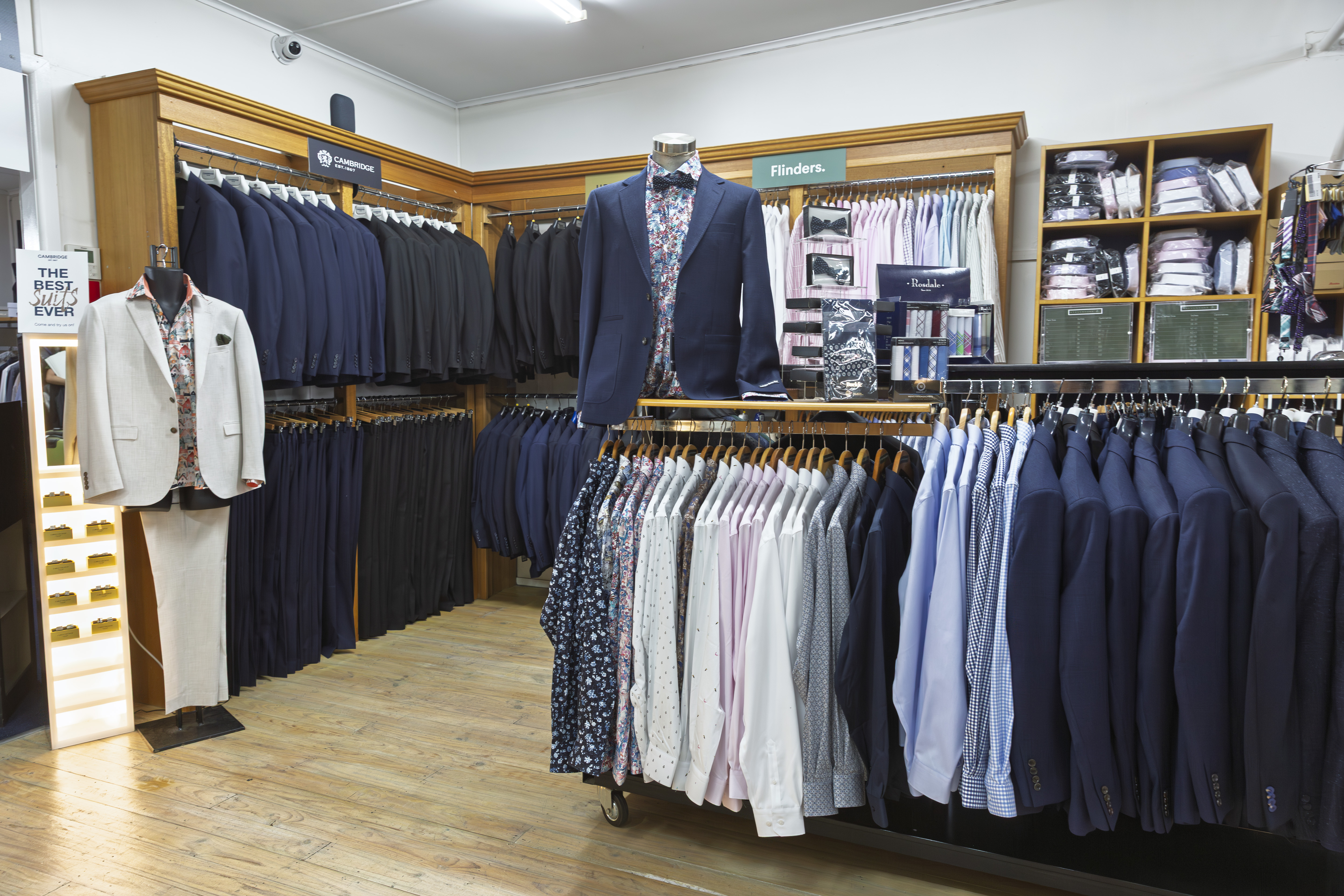 Menswear suiting section with Flinders shirts and formal wear on timber floors.