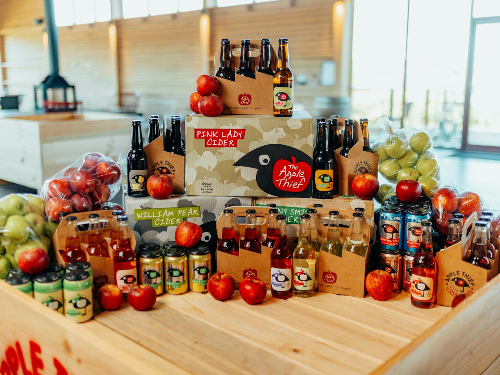 Apple Thief cider display with local apples and bottles.