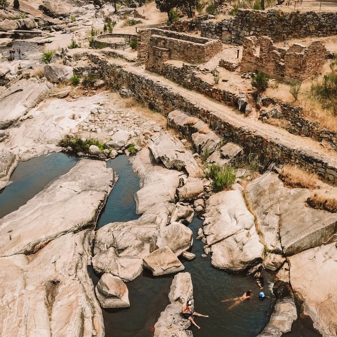 People swimming in natural rock pools near Tumut.